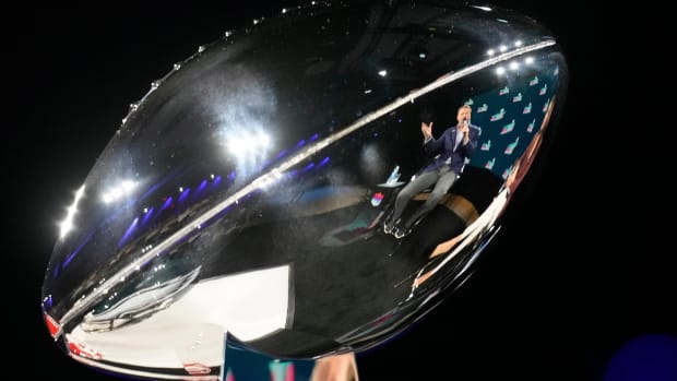 Reflected in the Vince Lombardi Trophy, NFL commissioner Roger Goodell answers a question during a news conference at the Phoenix Convention Center on Feb 8, 2023.